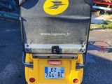 a yellow motorcycle with a number plate on the back of it