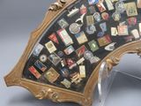 a mirror that has a lot of pins on it