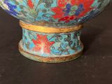a blue bowl with red and blue flowers on it