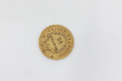 a close up of a gold coin on a white surface