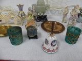 many different types of vases and figurines sitting on a table