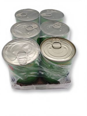 six cans of soda sitting in a plastic container