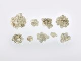 a close up of a bunch of coins on a white surface