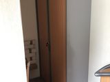 a closet in the corner of a room with a wooden floor