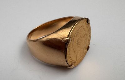 an image of a gold signet ring on a white surface