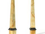 pair of marble obelisks on pedestals on a white background
