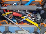a bag full of tools that are sitting on the ground