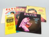 three elvis presley records are sitting on a table next to each other