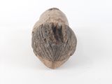 an elephant ' s head carved into a piece of wood on a white surface
