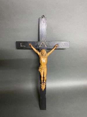 a wooden crucif with jesus on the cross on a gray background