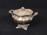 an antique silverplated sugar dish with a lid and handles
