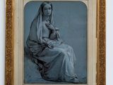 an old picture of a woman sitting in a chair with a veil on her head