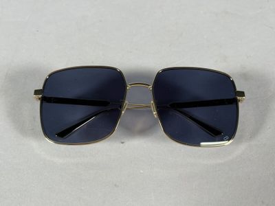 a close up of a pair of sunglasses on a white surface