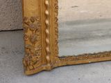 a mirror that is sitting on the ground next to a wall