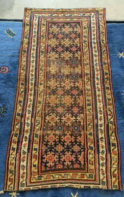 a blue rug with an oriental design on top of it
