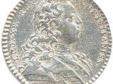 a close up of a silver coin with a woman on it