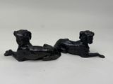 pair of black dog figurines on a white background