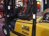 a yellow forklift truck parked in a warehouse