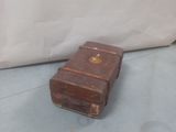 a brown suitcase sitting on the floor next to a white wall