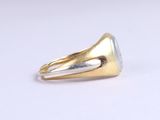 an image of a gold ring with a green stone on it