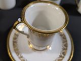 a cup and saucer sitting on a plate on a table