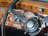 a steering wheel and dashboard of an old car