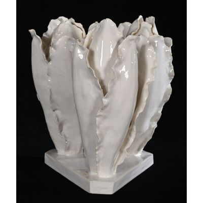 a white vase that has a bunch of shells in it
