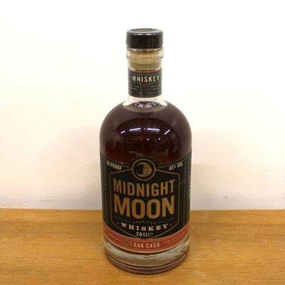 an image of a bottle of whiskey on a wooden table