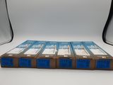 four boxes of blue and white film sitting on top of a white table