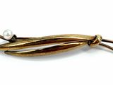 an image of a close up of a brooch with pearls on it