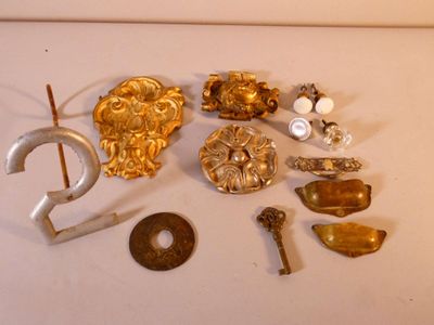 a lot of gold and silver items on a white surface
