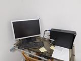 a glass desk with a computer and a keyboard on it