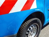 a blue van with a red and white stripe on the side of it