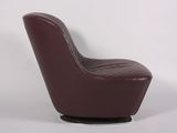 brown leather swive chair with chrome base and foot rest