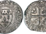 a silver coin with an image of a cross on it