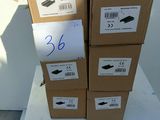 several boxes of shoes are stacked on top of each other on a table