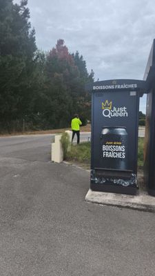 a man standing next to a sign on the side of the road