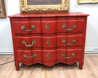 an image of a red chest of drawers in a room