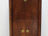 une photo d'une armoire en bois avec des ferrures en laiton