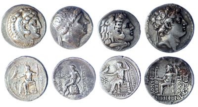 a close up of a bunch of silver coins on a white surface