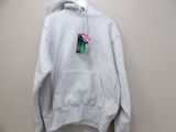 the hoodie is hanging on a hanger on the wall