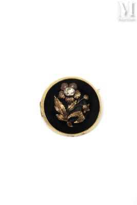 an image of a black and gold ring with a flower on it
