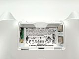 a close up of a wii controller with a battery