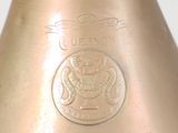 a close up of a metal vase with a seal on it