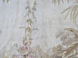 a painting of flowers and birds on the wall