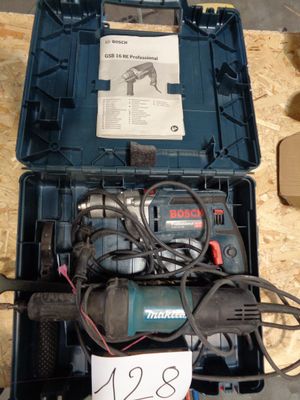 a box with a drill and other tools inside of it