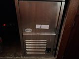 a small refrigerator in the middle of a cabinet