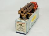a toy truck with logs on the back of it