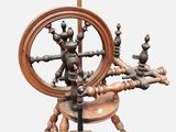a spinning machine with a wooden spinning wheel on a stand
