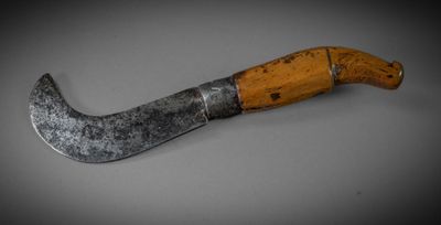 an old knife with a wooden handle on a table